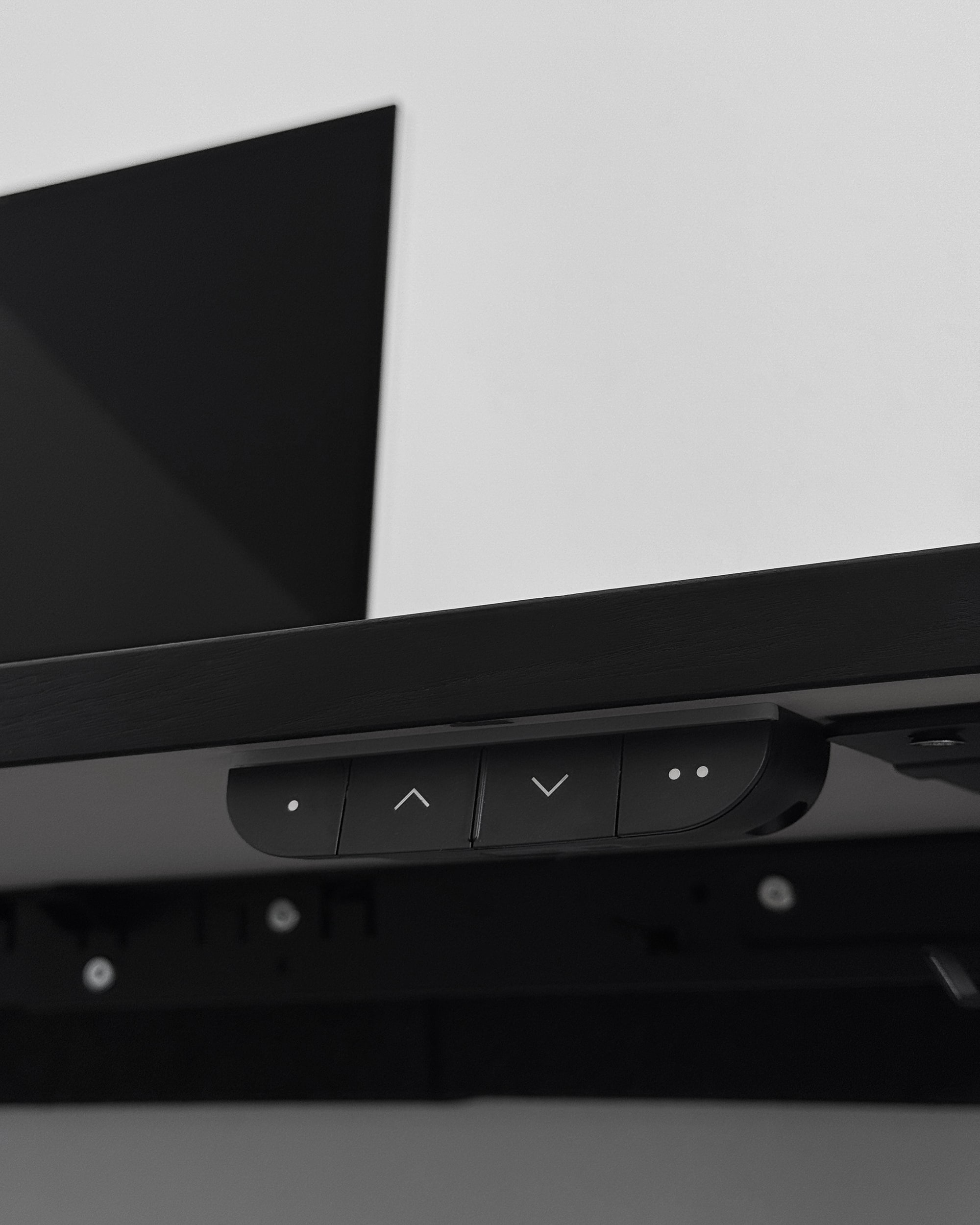 detail photo of the standing desk height controls